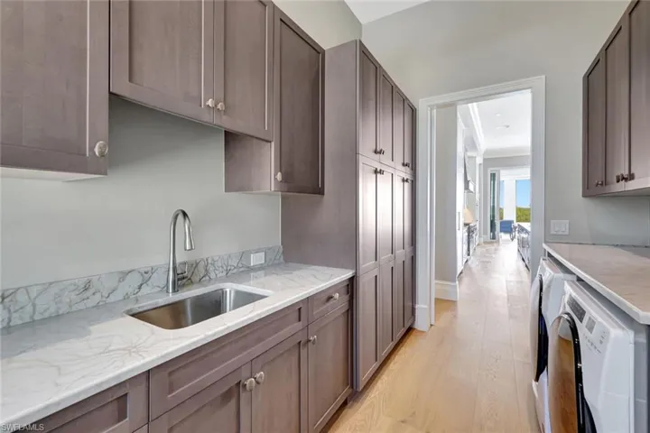 Laundry room with a sink, washing machine and clothes dryer