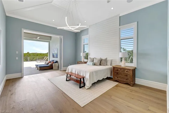 Master Bedroom featuring baseboards, light wood finished floors, a chandelier, access to exterior, and recessed lighting