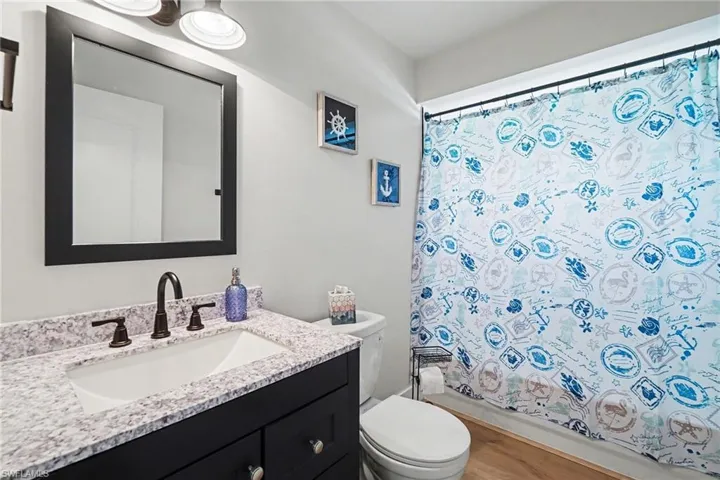 Blue vanity with integrated sink, speckled countertop
