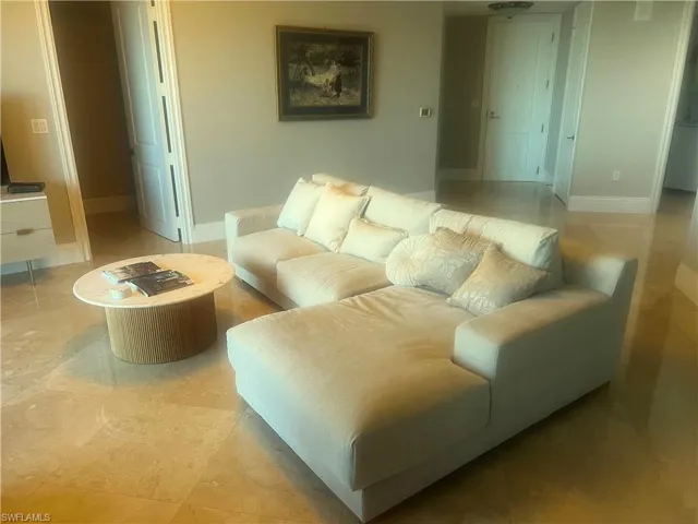Living room featuring baseboards and light tile patterned flooring