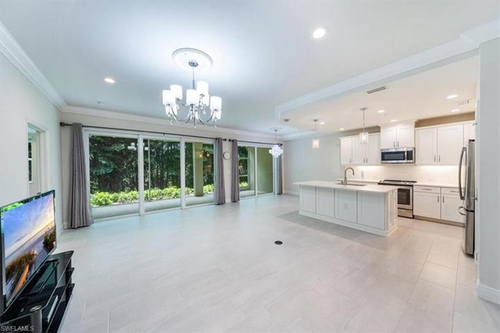 kitchen and living room - looking at impact sliders and private lanai