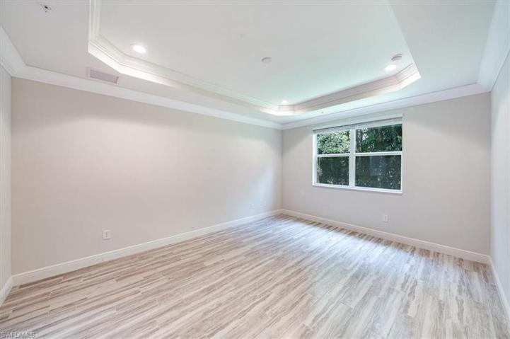Master bedroom with updated porcelain wood-look flooring
