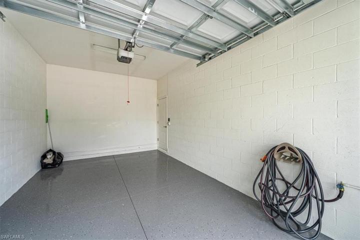 One-car garage and driveway with space for one more car and public parking just to the side of the building