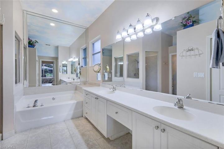 Expansive primary bathroom with soaking tub and dual sinks.
