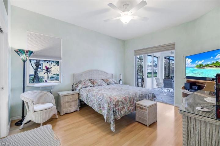 Primary bedroom suite with sliding glass door leading out to the pool.