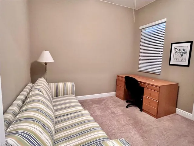 Home office/sitting area featuring desk with a sofa, can be used as an additional bedroom
