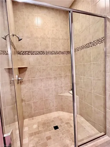 Full bathroom with a shower stall