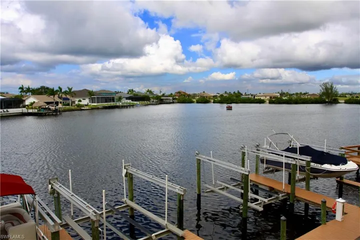 Dock area with boat lift and a water view