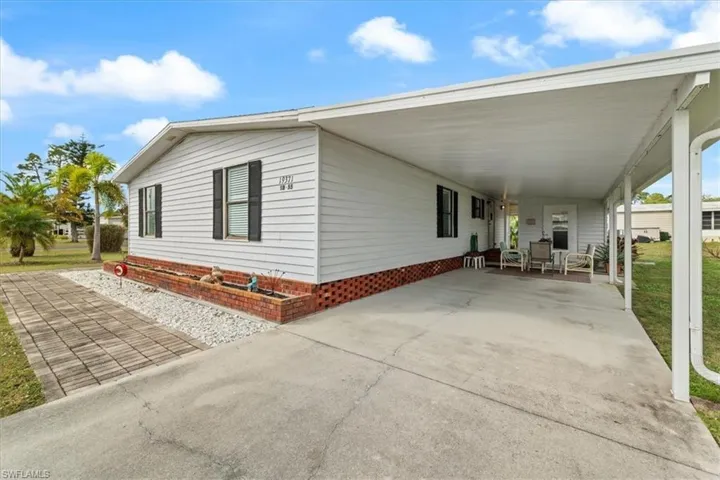 View of side of home with a carport