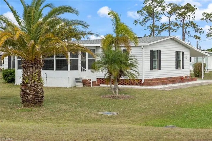 Rear view of house with a yard