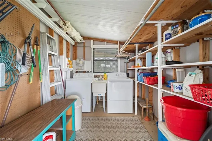 Storage room with separate washer and dryer and sink