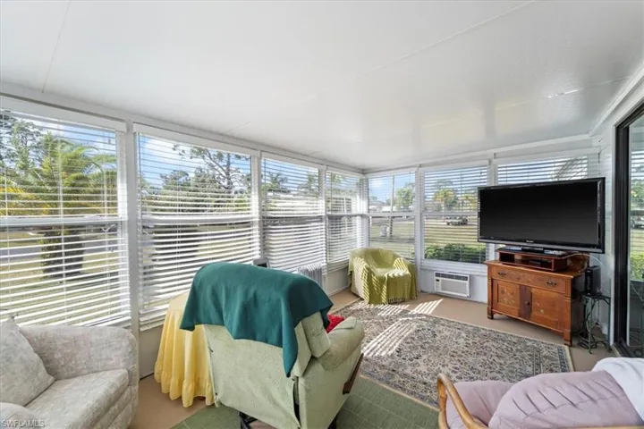 Sunroom featuring a wall mounted air conditioner