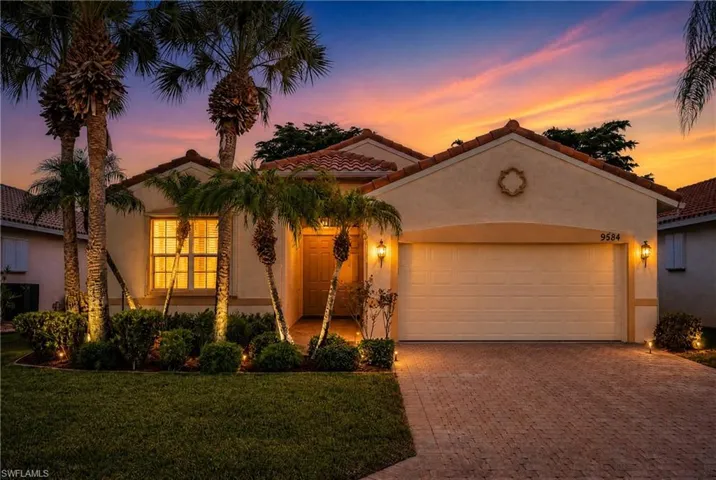 Mediterranean-style stucco exterior with a terra cotta tile roof