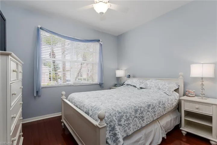 Hardwood-style flooring, ceiling fan, window with horizontal blinds, and recessed lighting