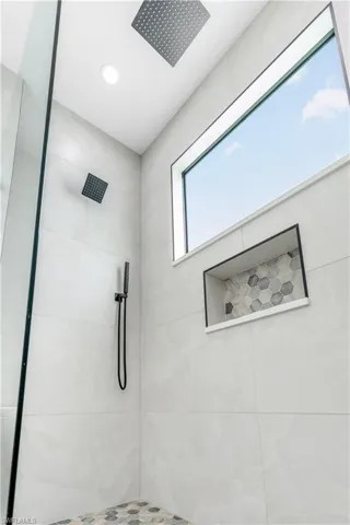 Bathroom with a tile shower and recessed lighting