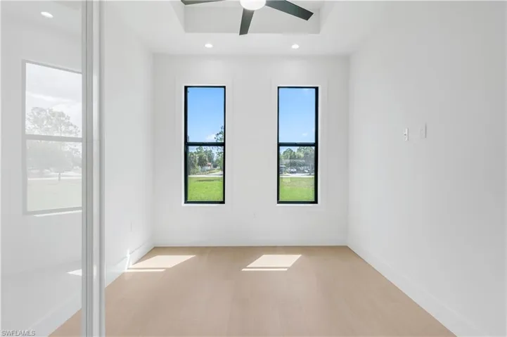 Den room featuring wood-look tile, ceiling fan, and recessed lighting