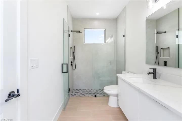 Bathroom featuring a stall shower and vanity