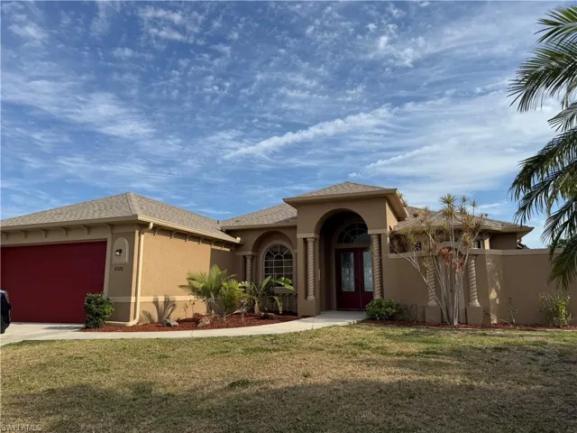 Mediterranean / spanish-style house with a garage, a front yard, and stucco siding