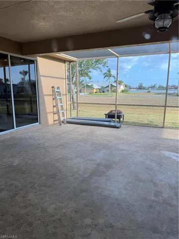 View of patio with a lanai