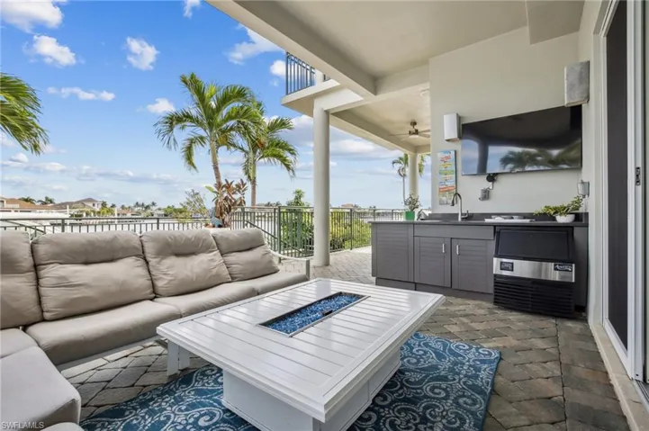 View of patio / terrace featuring an outdoor living space with a fire pit, an outdoor kitchen, and a ceiling fan