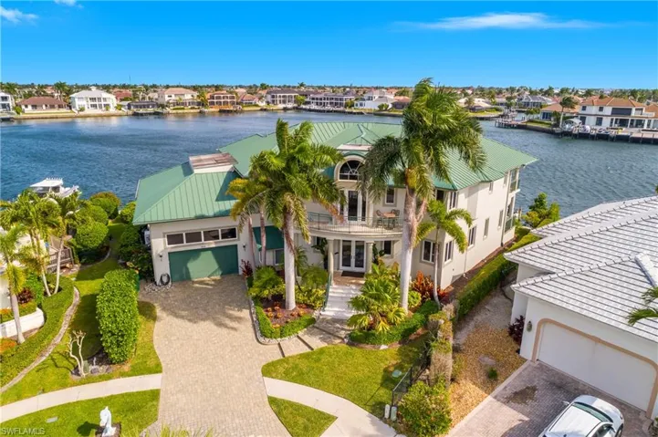 Aerial view of residential area featuring a large body of water