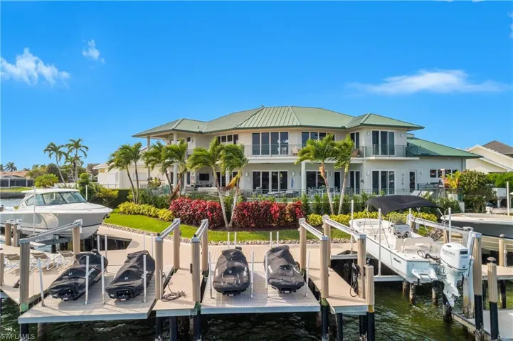 Dock area featuring boat lift and a water view