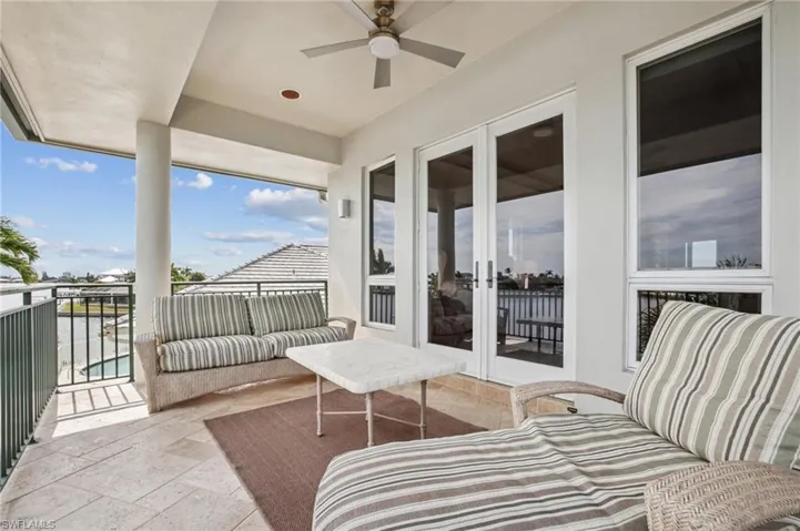 Balcony featuring ceiling fan, french doors, and an outdoor living space