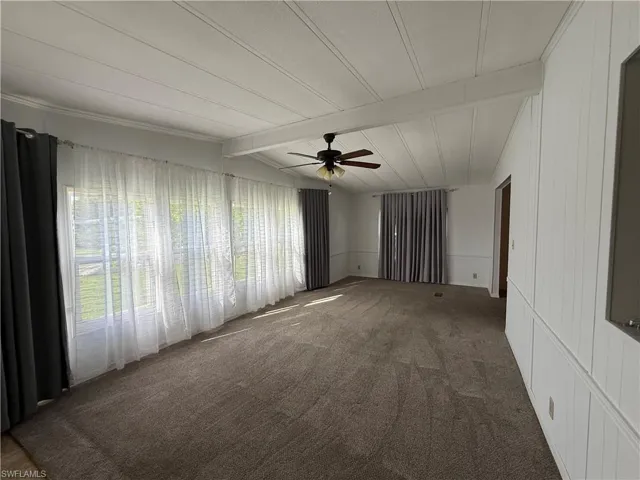 Spare room featuring carpet floors and ceiling fan
