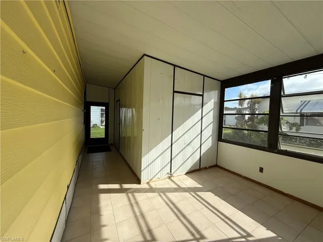 Unfurnished sunroom with a baseboard heating unit