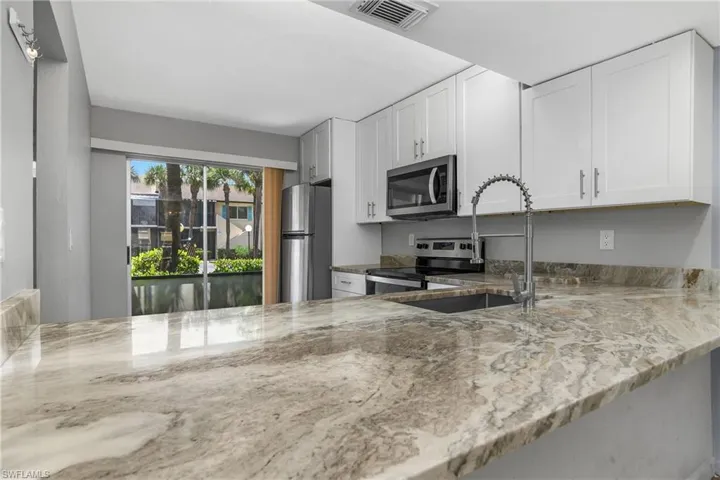 Open Kitchen with large countertop for bar stool seating