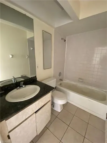 Full bathroom with vanity, shower / washtub combination, and light tile patterned floors