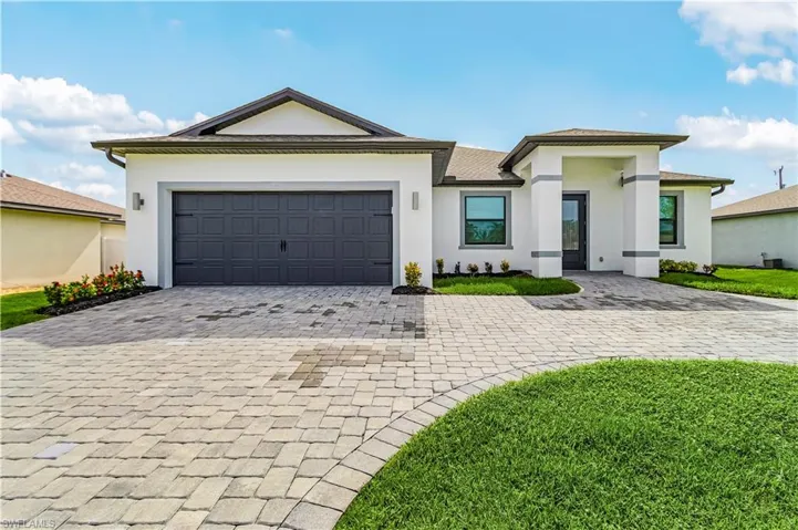 View of front of house with stucco siding, a front lawn, a shingled roof, and an attached garage