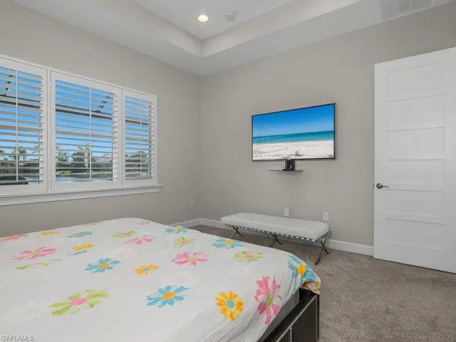 Master bedroom with a raised ceiling and recessed lighting, Eight foot shaker style doors throughout. Plantation Shutters.