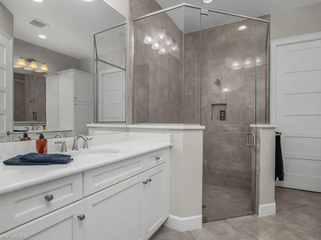 Master Bathroom with a large shower, dual vanities, and recessed lighting, frameless shower doors. Walk-in-Closet.