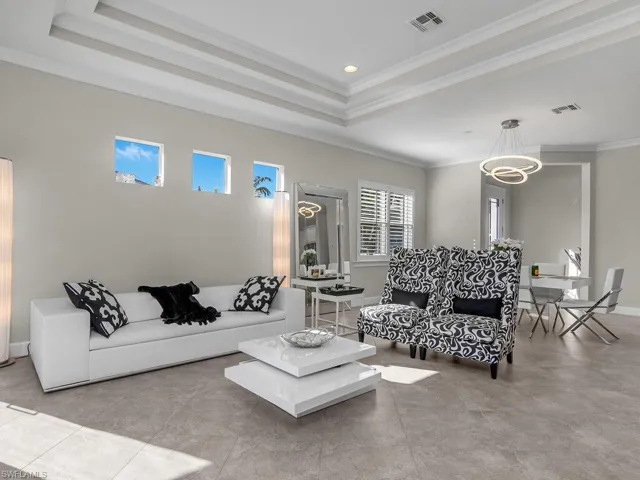 Living area with a tray ceiling, crown molding, and recessed lighting, Plantation Shutters, Entry.