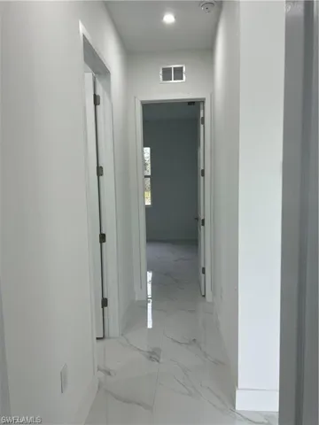 Corridor featuring light tile patterned floors