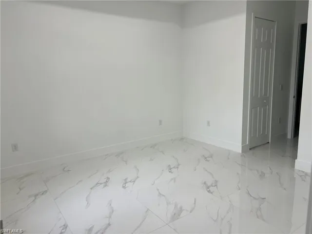 Unfurnished room with light tile patterned flooring