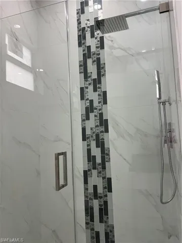 Bathroom featuring tiled shower