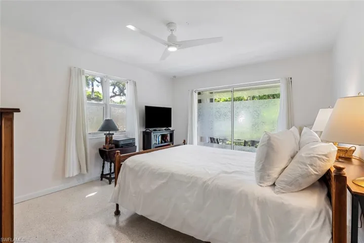 Bedroom featuring ceiling fan and access to outside