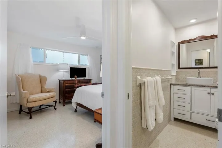 Bedroom featuring ceiling fan and sink