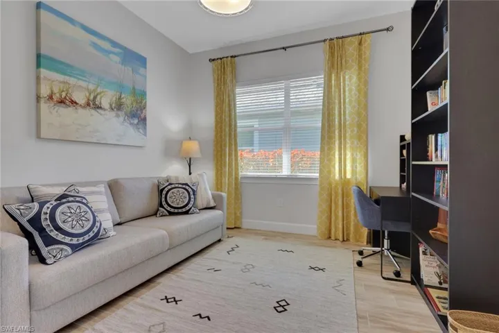 Home office with light wood-style floors and baseboards