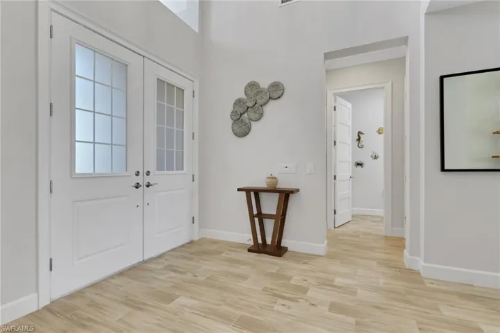 Foyer featuring light wood-type flooring and french doors