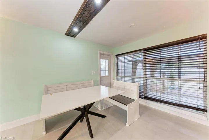 Unfurnished dining area with baseboards and a desk