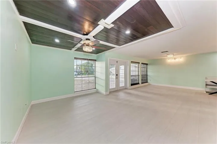 Empty room with french doors, light wood-style floors, recessed lighting, wooden ceiling, and a ceiling fan