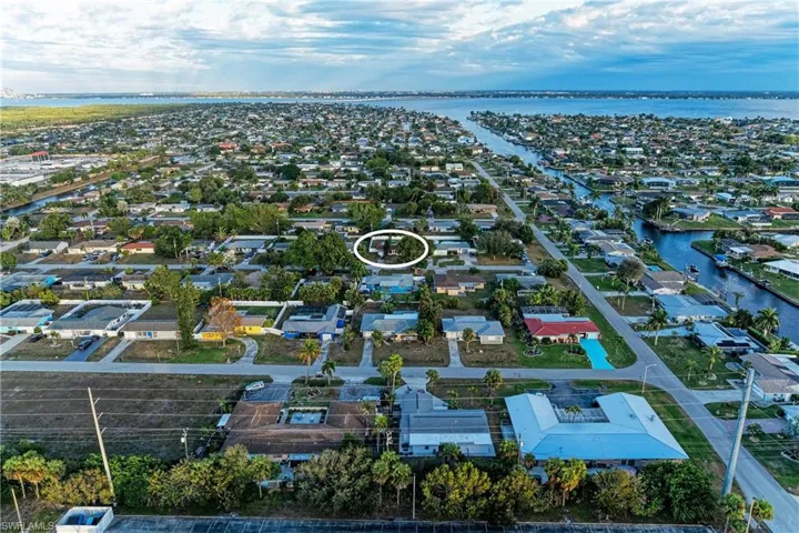 Aerial perspective of suburban area featuring a large body of water