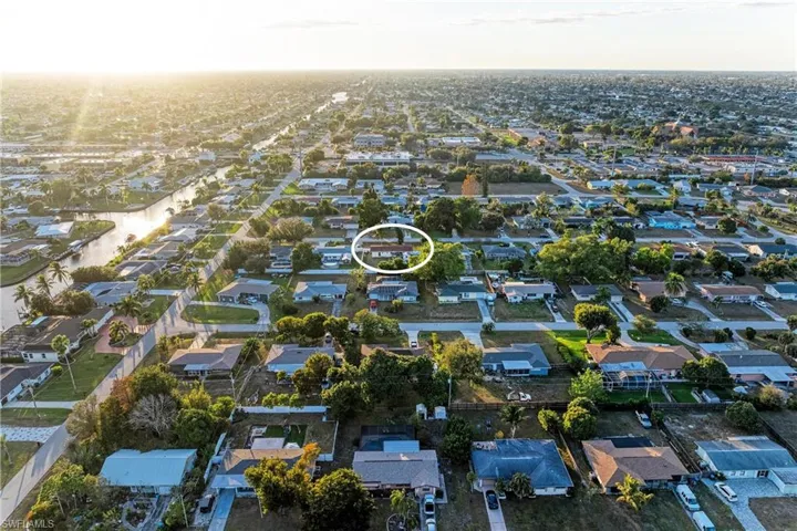 Aerial view of property's location featuring nearby suburban area
