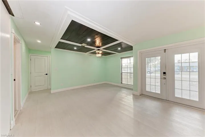 Empty room featuring a ceiling fan, french doors, recessed lighting, and light wood-style floors