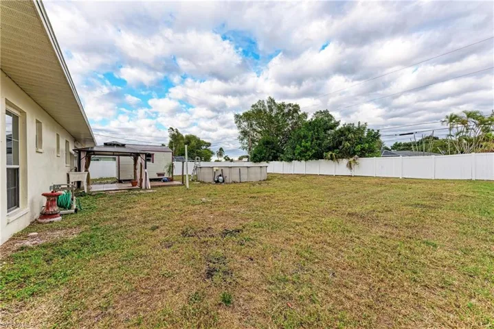 Fenced backyard with a gazebo and a patio area