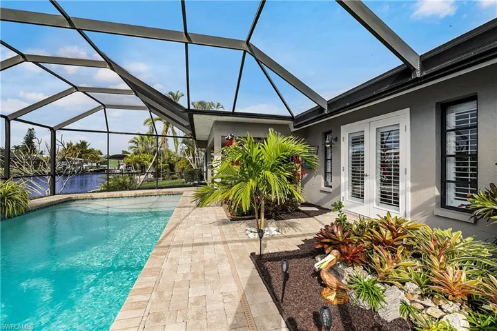View of swimming pool with a patio area, a lanai, and french doors