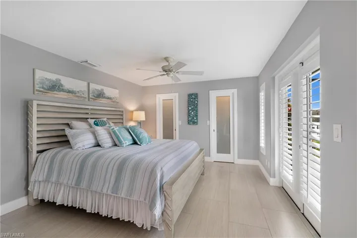 Bedroom featuring plantation shutters and beautiful closet doors